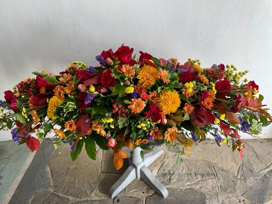 Autumnal Casket Spray made with beautiful Autumn colours